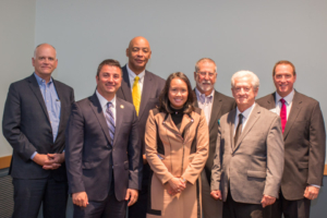 A posed portrait of the speakers at the event.